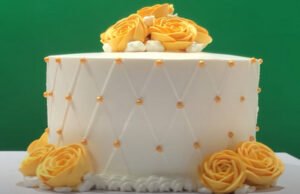 A beautifully frosted cake with icing rose